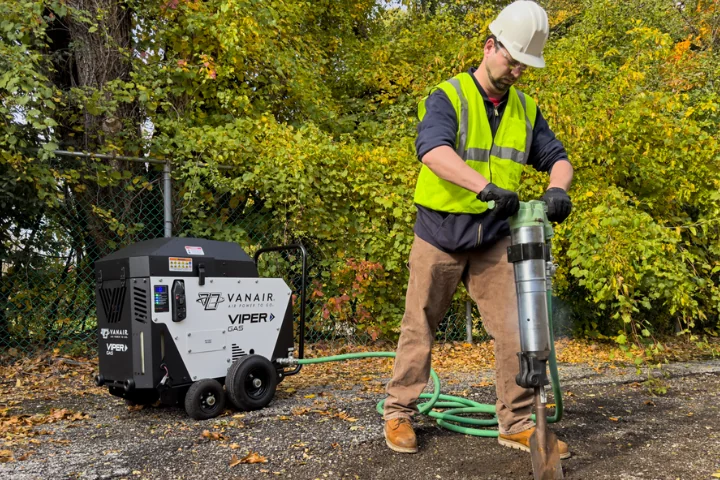 Vanair Viper Gas air compressor powering a paving breaker on a jobsite