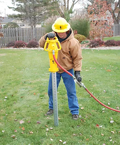 Rhino PD-55 pneumatic post driver setting a channel post