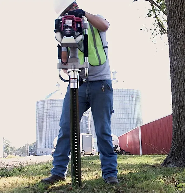 Rhino Multi-Pro gas post driver setting a U-channel sign post