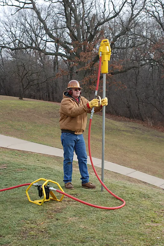 Rhino PD-55 pneumatic post driver in use with FRL air preparation unit