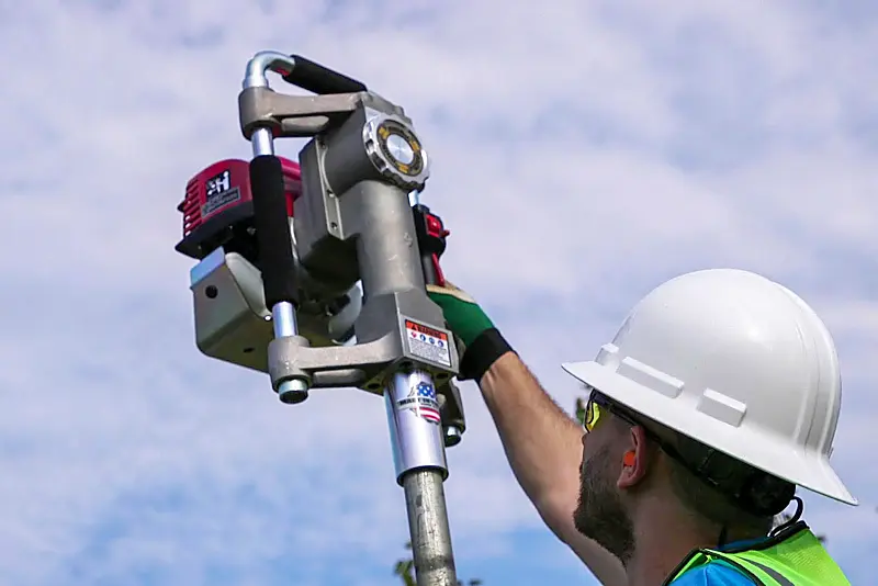 Rhino Ranch Pro GPD-30 gas post driver setting a metal pipe fence post