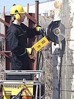 man using cut off saw